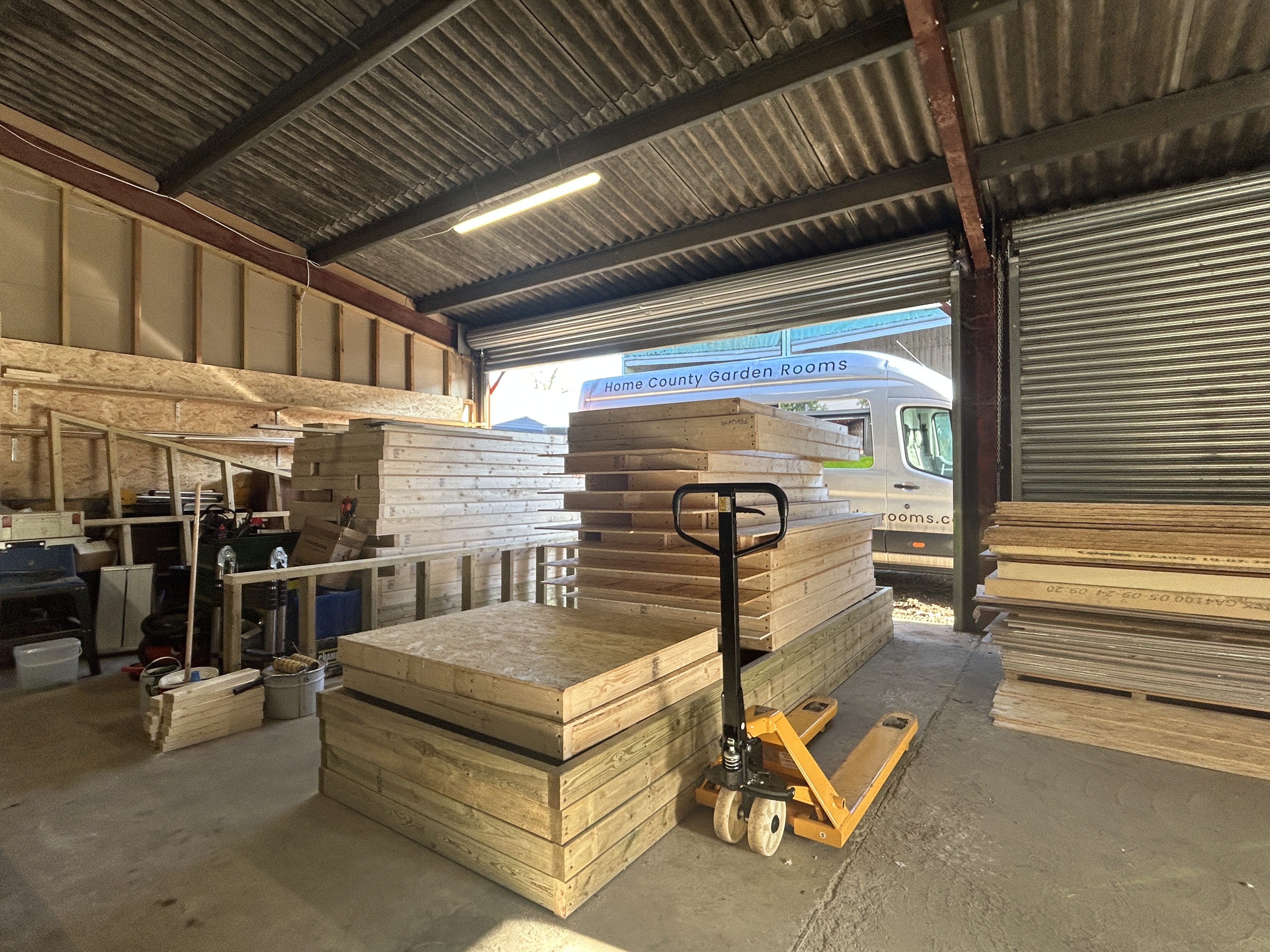 A house under construction with a roof and a window being installed.