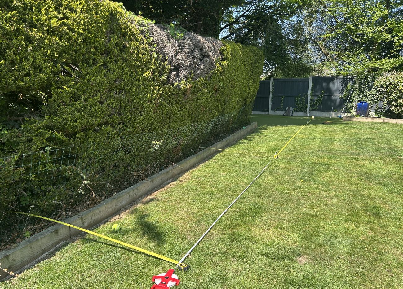 Wooden decking and fence in backyard, creating a cozy and inviting outdoor area.
